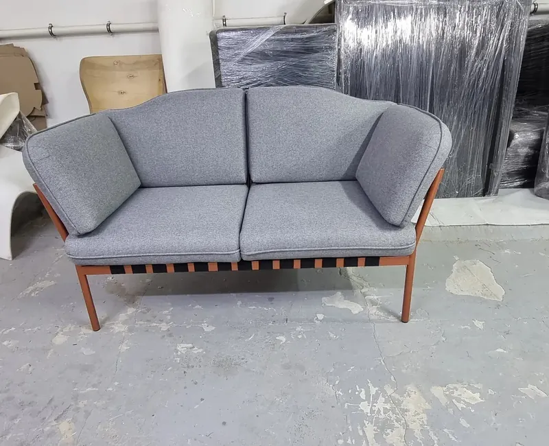 Sofa on an orange steel frame in the KARLSON factory