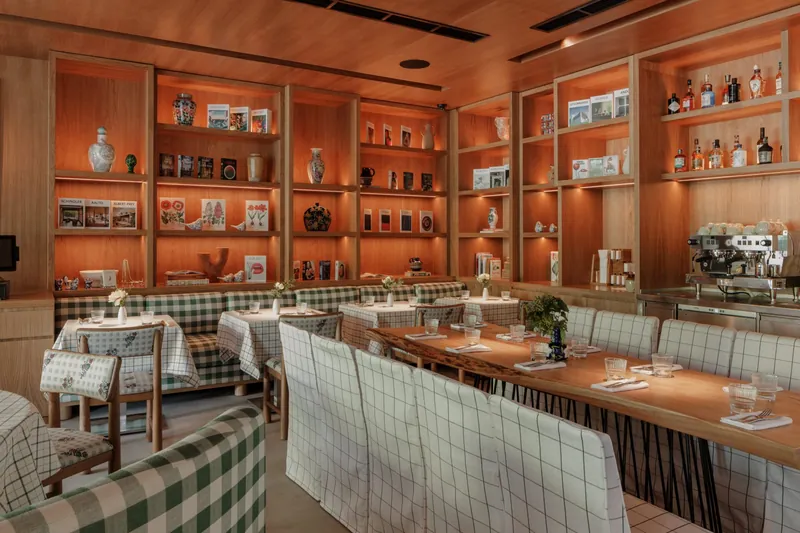 Long banquette along lit timber shelving