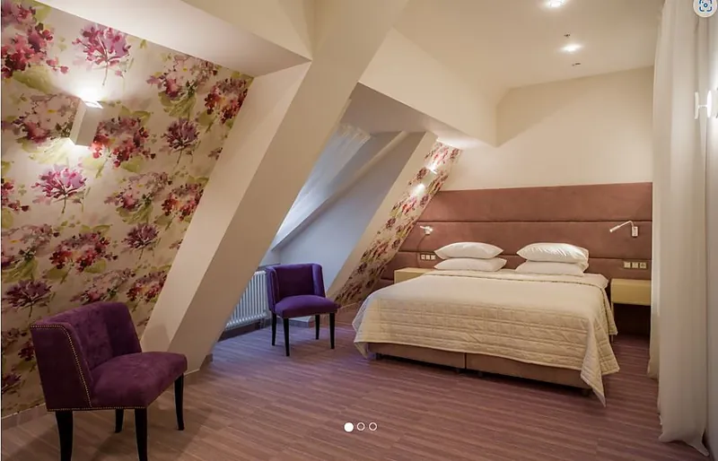 Attic guest room with a purple armchair
