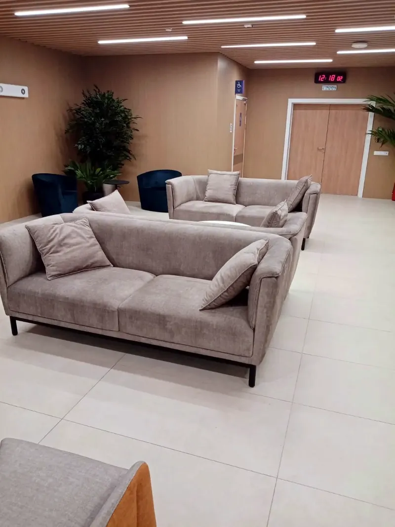 Grey sofas with cushions in a waiting area
