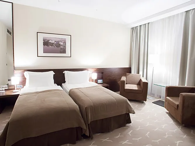 Hotel room with two brown armchairs