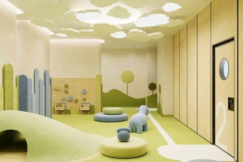 Playroom with soft upholstered wall panels, a tunnel hill and round poufs