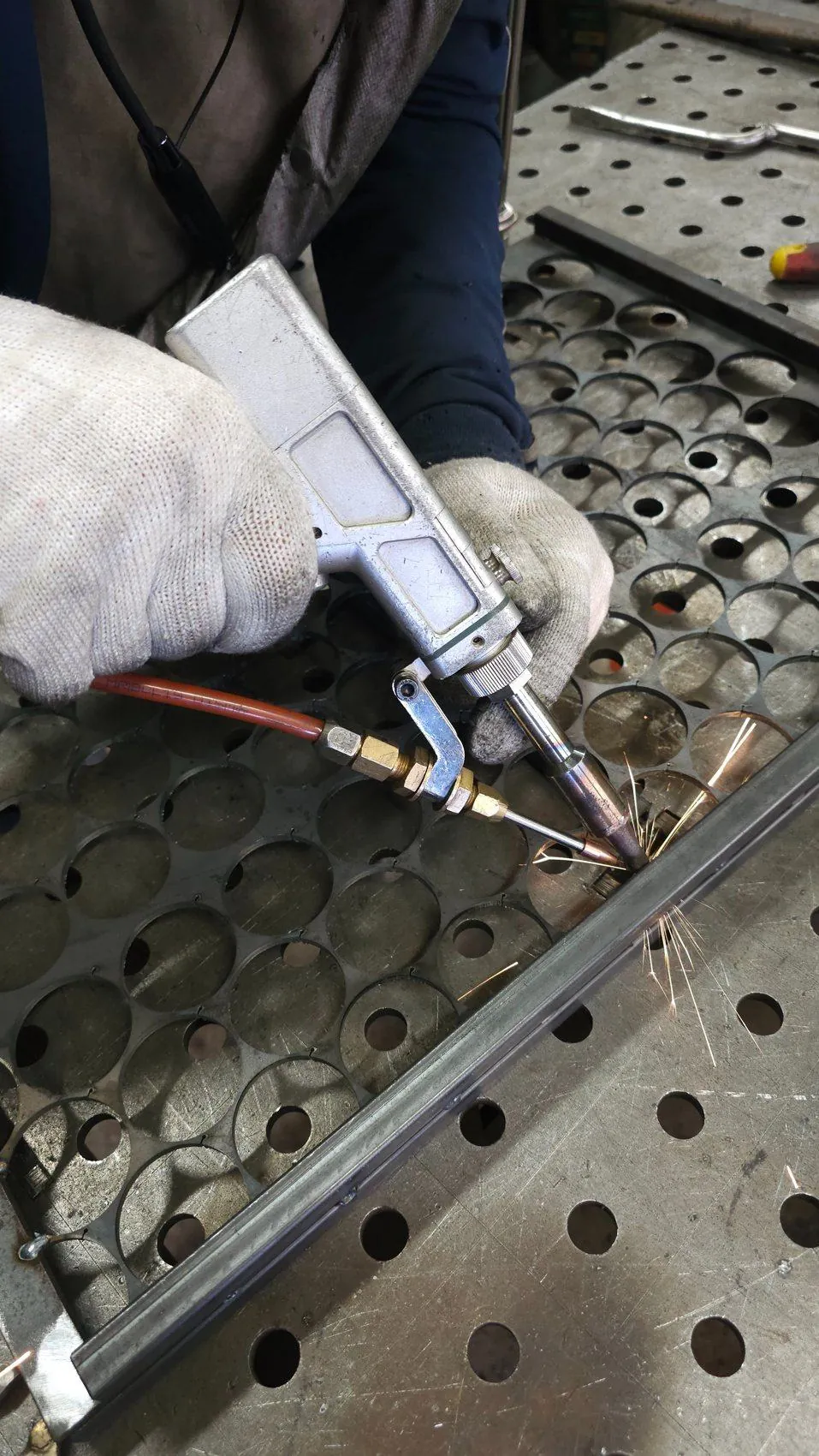 Laser welding of a perforated steel part