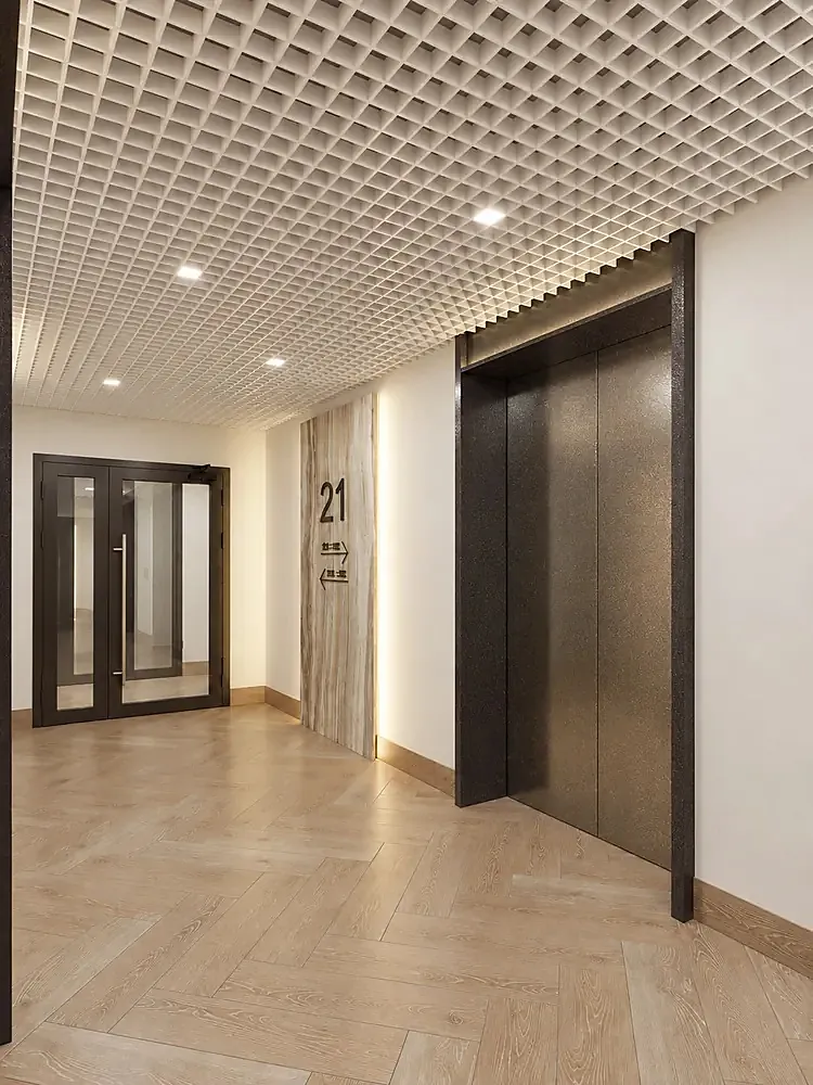 Residential lift lobby with a dark steel portal surround and timber floor