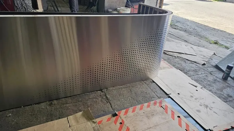 Radius reception cladding in perforated stainless steel in the workshop