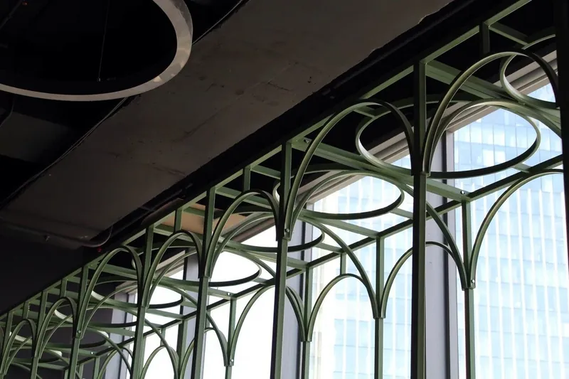 Arched steel frames rising from the window line into the ceiling