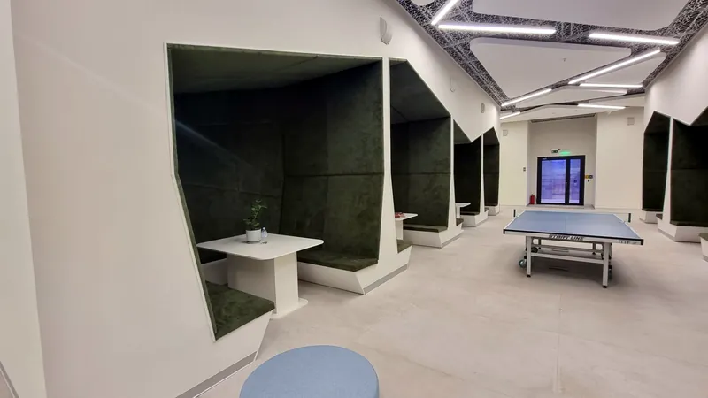 Acoustic work booths lined with green upholstery