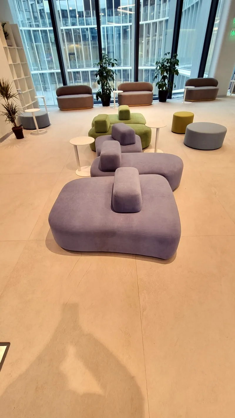Lilac modular island sofa with round poufs