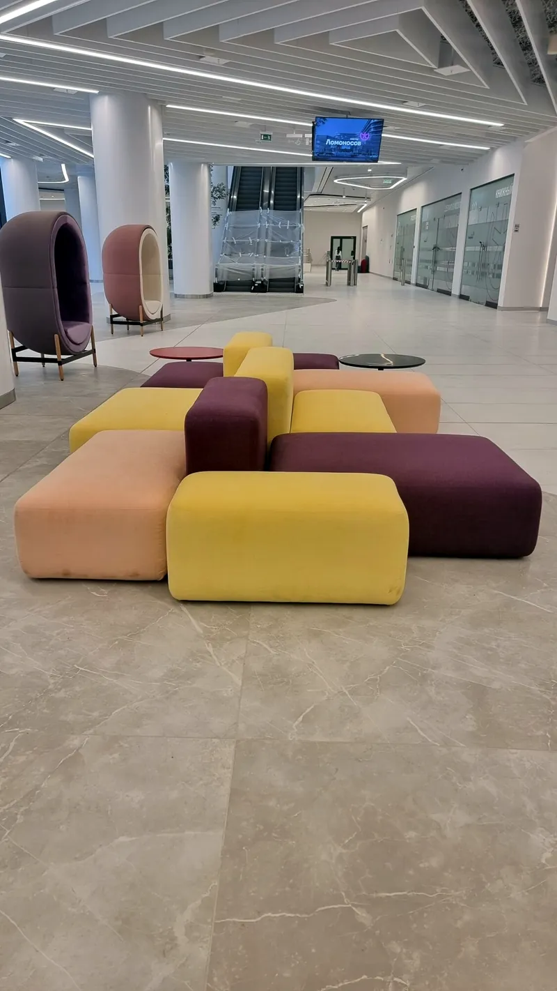 Low modular sofas in plum, pink and yellow